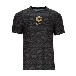 Men's black pre-match football jersey with patterned fabric and gold chest crest
