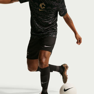 Men's black patterned football jersey with gold chest crest, short sleeves