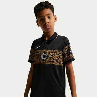 Youth black soccer jersey with gold geometric panel across chest and short sleeves