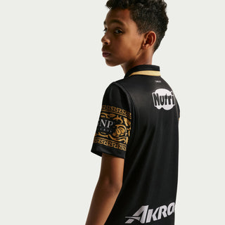 Youth black soccer jersey back with gold trim, Nutri logo, and AKRON sponsor text