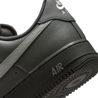 Men's Air Force 1 low-top sneaker close-up, dark olive panels with black Air heel detail