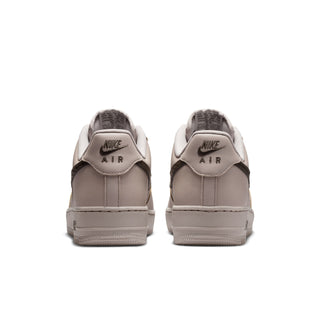 Men's low-top sneakers, heel view, light beige leather with Nike Air logo on insole