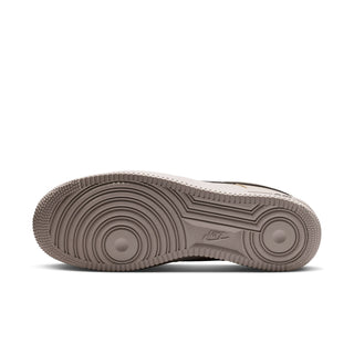 Men's low-top sneaker outsole view, textured tread with light beige midsole