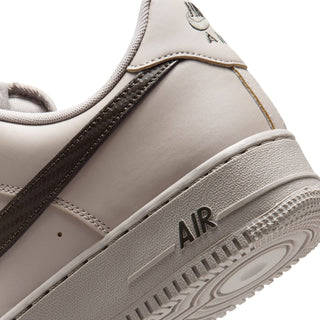 Men's low-top sneaker close-up, light beige upper with Air text on midsole