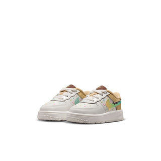 Toddler Nike sneakers, angled pair, white with teal accents and multicolor details