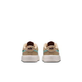 Toddler white Nike sneakers, rear view, teal heel panel and multicolor details