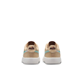 Kids' sneakers rear view in white and tan with teal heel stripe and Nike logo