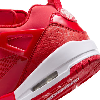 Red sneaker quarter close-up with textured paneling, white midsole, and air window