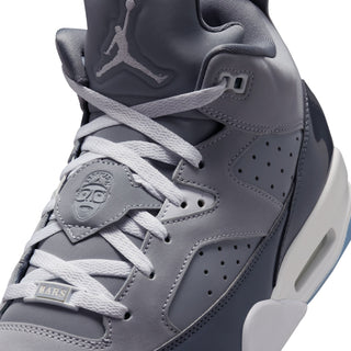 Close-up of cool grey sneaker tongue and laces with embossed face patch