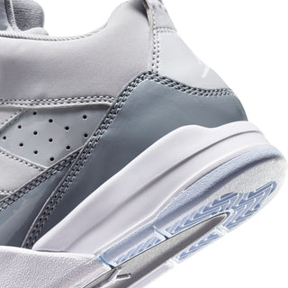 Kids' sneaker side close-up with cool grey overlays, stitched seams, and blue-tinged sole