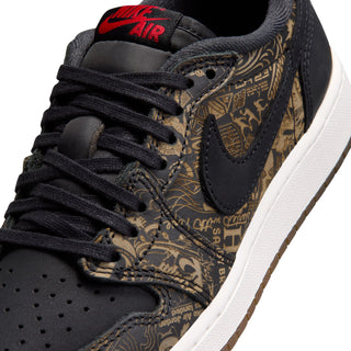 Youth low-top sneaker close-up, black laces, gold print overlays, red Nike AIR logo