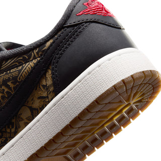Youth low-top sneaker close-up, black upper with gold pattern, white sole, red swoosh