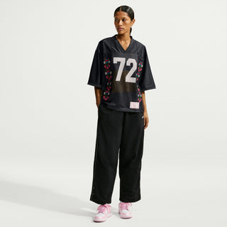 Black jersey T-shirt with '72' graphic, worn with matching wide-leg pants