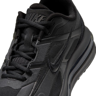 Close-up of black lace-up upper with Nike Swoosh, mesh panels, and cushioned tongue