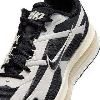 Nike Air Max sneakers closeup, black laces and swoosh on pale ivory upper