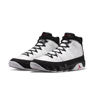 White and black high-top sneakers with red Jumpman logo on the side