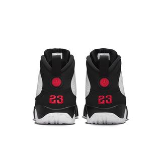 Back view of white and black high-top sneakers with red '23' branding