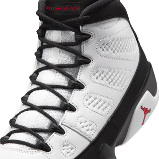 Close-up of white high-top sneakers with black laces and quilted paneling