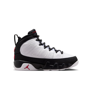 Mid-top youth sneakers in white with black panels and red Jumpman accents