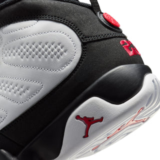 Close-up of youth sneaker side, black and white panels with red Jumpman and sole detail