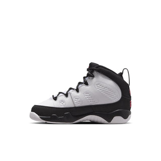 Kids high-top sneaker side profile, white leather-look upper with black collar and red tag.