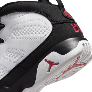 Kids high-top sneaker heel close-up, black and white panels with red Jumpman emblem.