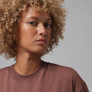 Brown crew-neck graphic tee with light pink "Friday" script logo