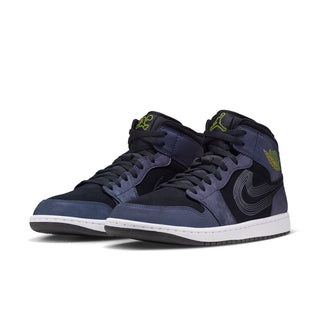Pair of mid-top navy sneakers with black laces, black swoosh, neon green branding