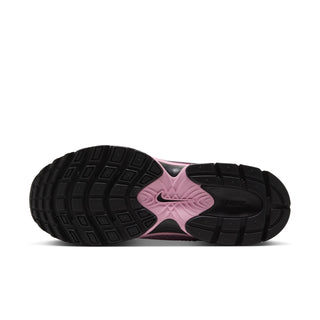 Women’s sneaker outsole view in black with pink midfoot and textured traction tread