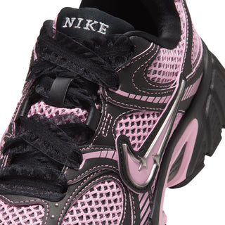 Close-up of black Nike lace-up sneaker with pink mesh panels and swoosh