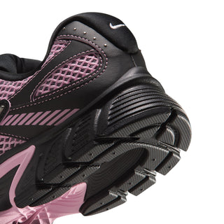 Close-up of women’s black and pink sneaker toe and outsole tread with pink trim