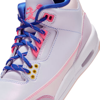 Youth retro sneakers close-up, white upper with blue laces and pink wing-style patch