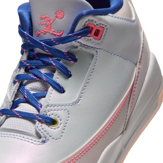 Close-up of sneaker laces, pink eyelet, and pink stitching on a light gray upper