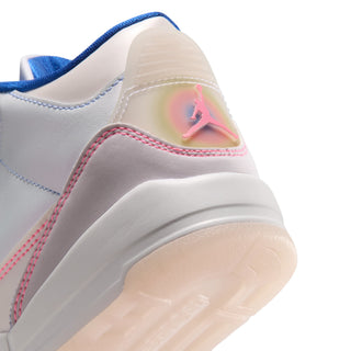 Close-up of sneaker heel with pink logo, stitched panels, and translucent outsole