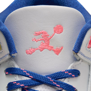 Close-up of pink embroidered logo and blue laces on the sneaker tongue