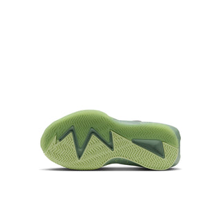 Kids sneaker outsole in neon green with tread pattern, underside view