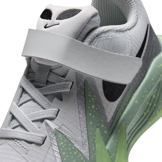 Kids sneaker close-up: light-gray upper with black Swoosh and neon-green graphic