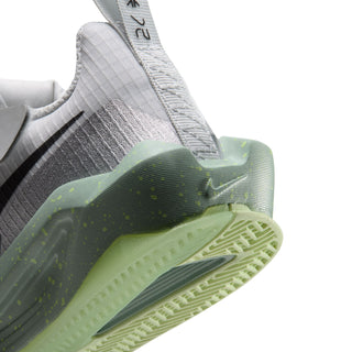 Kids sneaker close-up: heel and neon-green outsole with tread and logo details