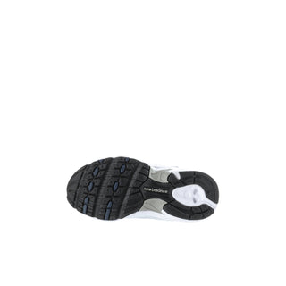 Toddler New Balance sneakers outsole view, white uppers with dark rubber tread