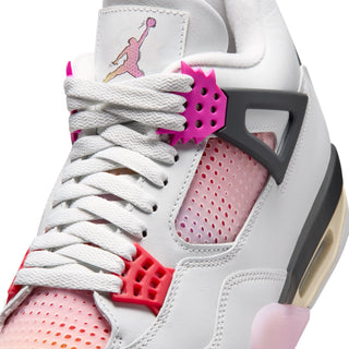 Men's sneaker close-up: white laces, pink perforated side panel, Air Jordan tongue graphic