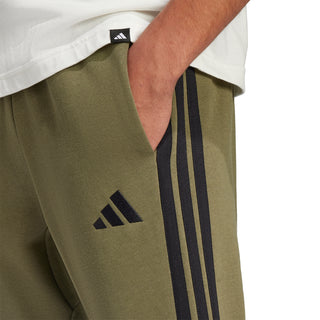 Men's olive fleece pants close-up of black three stripe side panel