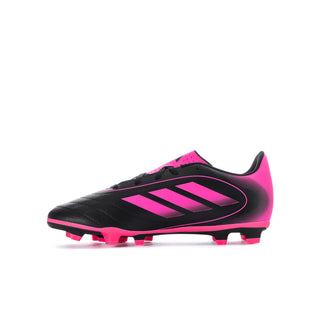 Youth soccer cleat, black-and-hot-pink upper with pink heel tab and molded studs