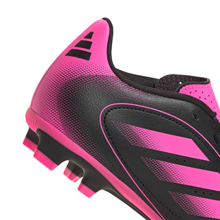 Youth soccer cleat side view, hot-pink textured panel and black comfort collar