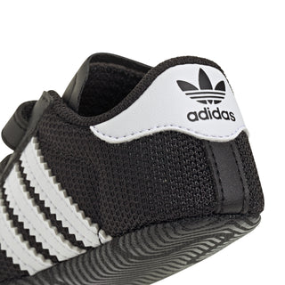 Infant black adidas Superstar sneaker with white side stripes and adidas trefoil patch