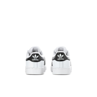 Kids' white adidas sneakers with black heel tabs and lace-up design.