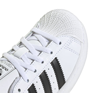 Kids' white sneaker upper with laces, textured toe cap, and black side stripes.