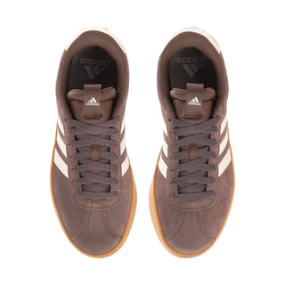 Women’s suede court sneaker front view pair with brown laces, white stripes, gum accents