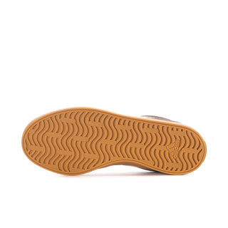Women’s sneaker outsole with tan rubber tread pattern and branded heel detail