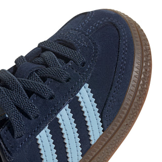 Toddler navy sneaker close-up with light blue stripes and gum rubber sole