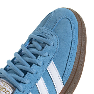 Light blue youth adidas sneaker heel and laces, suede upper, white stripes, brown sole